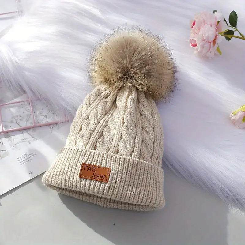 Gebreide pompom muts