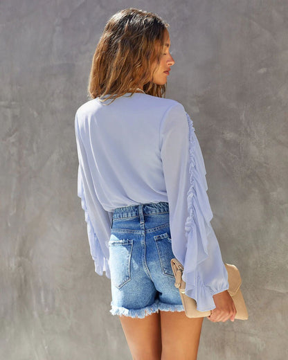 Lichtblauwe body met ruffles